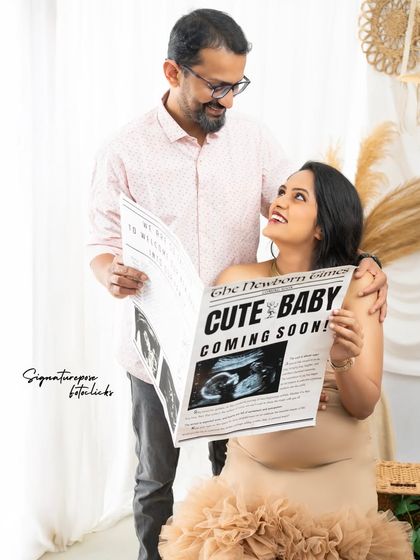 The couple shares a look of joy while reading the "news," making for a candid and happy memory.