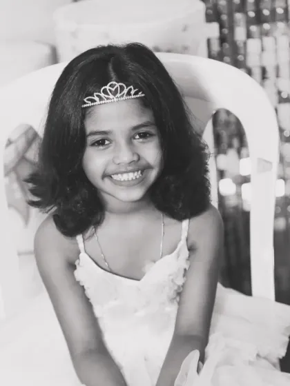 The pure, unfiltered joy of childhood. This black and white portrait of a young girl celebrating a milestone is a perfect example of a memory documented in its rawest form. These are the moments, the genuine smiles, that I live to capture for families to hold onto forever.