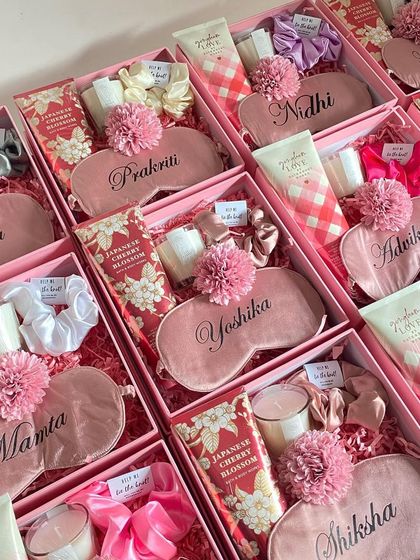 A full view of a large order of bridesmaid hampers, each with a custom eye mask, Bath & Body Works cream, and a scented candle.