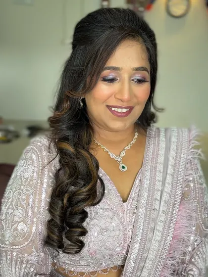 A soft and romantic look for this client. The makeup features a shimmery lavender eyeshadow and a mauve lip.