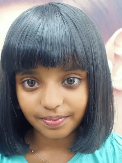 A classic bob with a full fringe for a young girl. This is a timeless and adorable haircut that is perfect for kids.