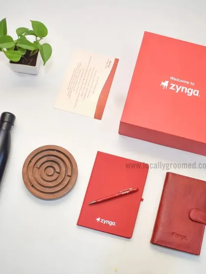 Another fantastic welcome kit we created for Zynga. This one includes a branded water bottle, a red notebook and pen, a leather-style diary, and a wooden maze game for a touch of fun.
