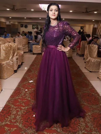 A stunning purple gown for a birthday girl. The sequined bodice and full tulle skirt make this a perfect choice for feeling like a princess on your special day.