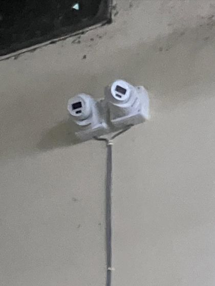 A custom dual-camera mount to monitor two directions from a single point. This is a smart solution for covering long corridors or aisles.