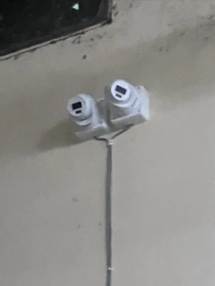 A custom dual-camera mount to monitor two directions from a single point. This is a smart solution for covering long corridors or aisles.