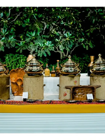 A traditional Indian buffet setup using rustic earthenware and elegant copper-lidded serving dishes. This presentation style is perfect for showcasing authentic regional Indian cuisines.