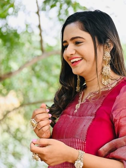 The best feeling is watching a client adore our pieces. Here, she is styling our iconic golden tassel earrings with a beautiful pink suit, looking absolutely graceful.