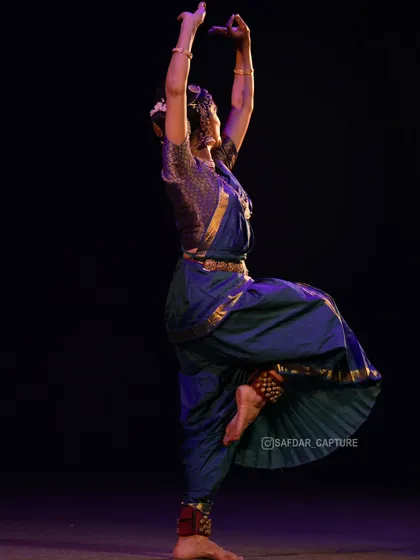 A pose that reaches upwards, conveying a sense of aspiration or devotion.
