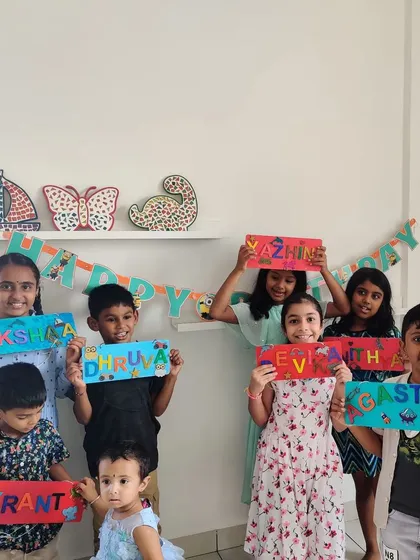 Look at these proud smiles! Kids at a birthday party showing off the colorful, personalized nameplates they designed and created all by themselves. It's the perfect party favor to take home.