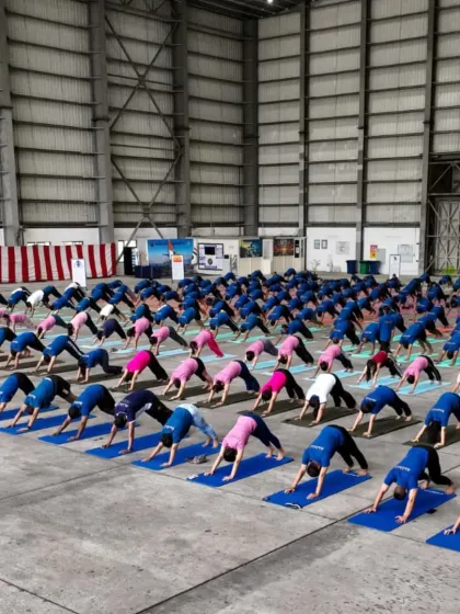 Naval officers practicing Adho Mukha Svanasana (Downward-Facing Dog). This posture is excellent for strengthening the entire body and improving circulation.