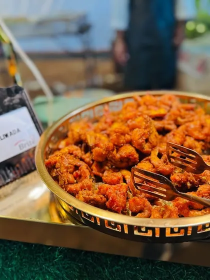 A bowl of spicy and flavorful Prawns Koliwada, a Mumbai-style fried prawn dish that is always a crowd-pleaser.