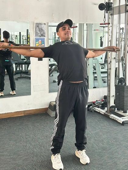 Completing a set of mobility exercises with a stick. Flexibility is just as important as strength.