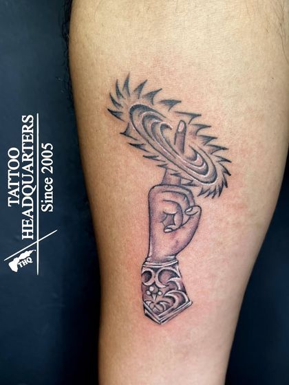 A depiction of Lord Vishnu's hand holding the Sudarshana Chakra, a symbol of divine power, protection, and righteousness.