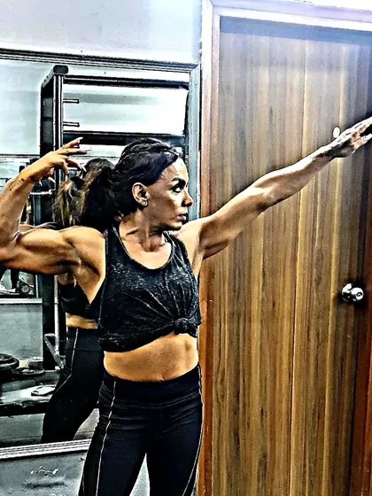 Practicing a classic bodybuilding pose. This helps build the mind-muscle connection needed to control your physique on stage.