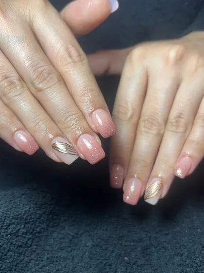 A simple and elegant set of square-shaped nails with a shimmery pink base and subtle gold line accents.