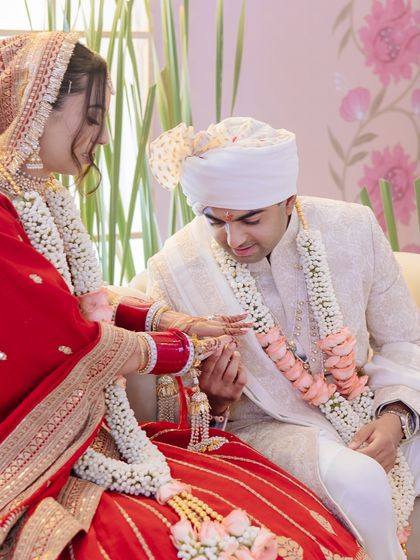 A quiet moment during an intimate wedding ceremony, as the groom gently holds the bride's hand.
