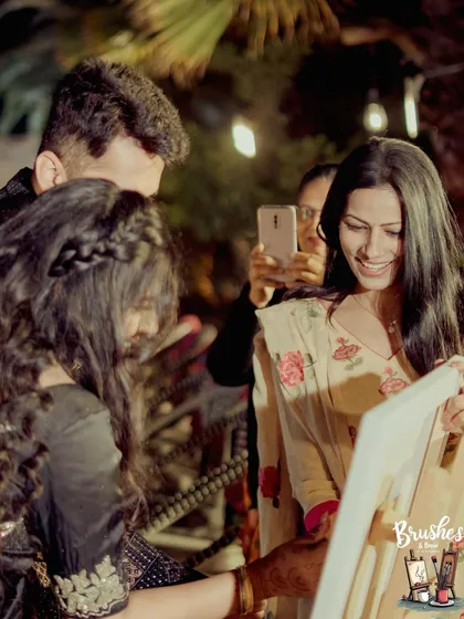 This is me, Isha, helping a guest add their touch to the wedding canvas. It's an interactive experience that gets everyone involved in creating a collective gift of love.