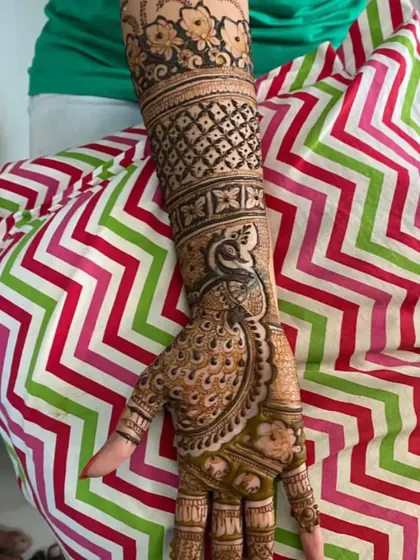 Another view of our popular peacock bridal mehndi. We ensure every detail is perfect, from the feathers on the hand to the floral patterns on the arm.