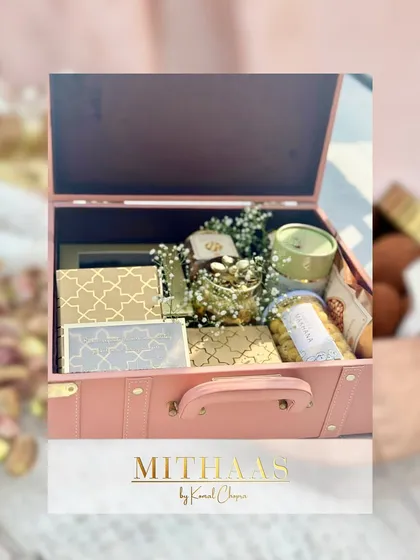 This elegant pink trunk is one of my most popular choices for bespoke hampers. Here, it's opened to reveal a curated selection of treats nestled amongst delicate baby's breath, ready for a special occasion.
