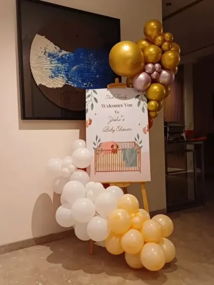 A personalized welcome easel is a great way to greet guests. For this baby shower, I designed a custom sign and decorated it with a matching balloon cluster.