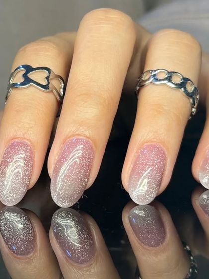 Another view of the soft pink cat-eye nails, showing the beautiful light-reflecting properties.