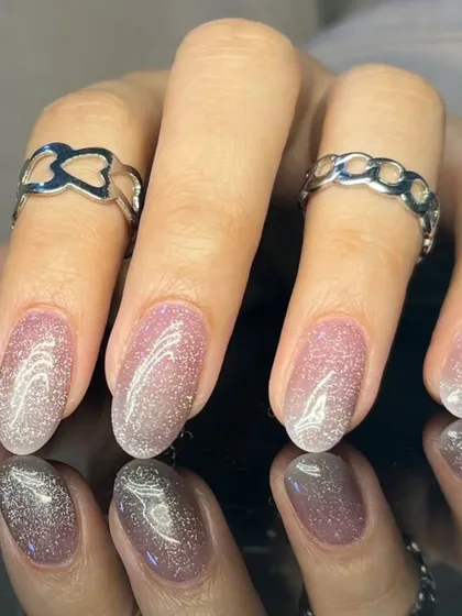 Another view of the soft pink cat-eye nails, showing the beautiful light-reflecting properties.