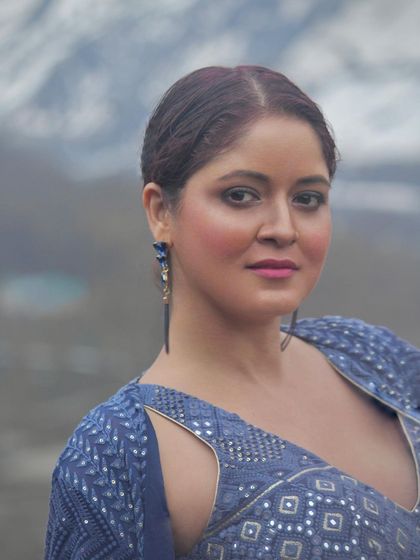 A final close-up portrait of the model in our stunning blue co-ord set.