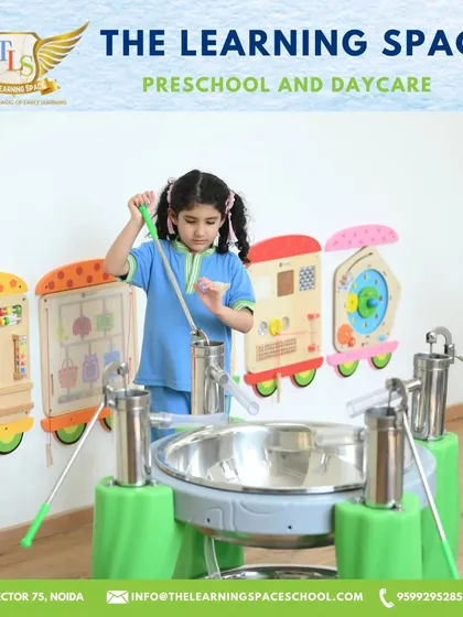 A young girl plays a large steel drum instrument. Our music area is designed to be accessible and engaging for children of all ages, encouraging them to make some joyful noise.