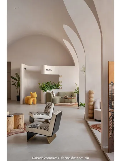 We designed this sales office in Mumbai as a harmonious blend of modern minimalism and organic warmth. The space is defined by its sculptural, vaulted ceilings and flowing walls, creating a tranquil yet sophisticated environment for business. We used a neutral palette and natural materials to craft a space that is both functional and sensory.