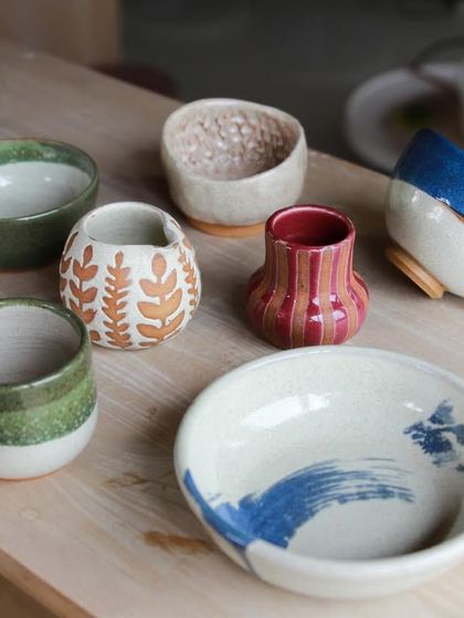 The first student showcase of 2024, featuring a vibrant collection of bowls, cups, and vases with diverse surface decoration techniques like Mishima and wax resist.