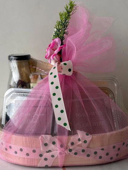 A beautifully wrapped pink hamper, the perfect surprise to show up at her door. It's a sweet way to say you're thinking of her.