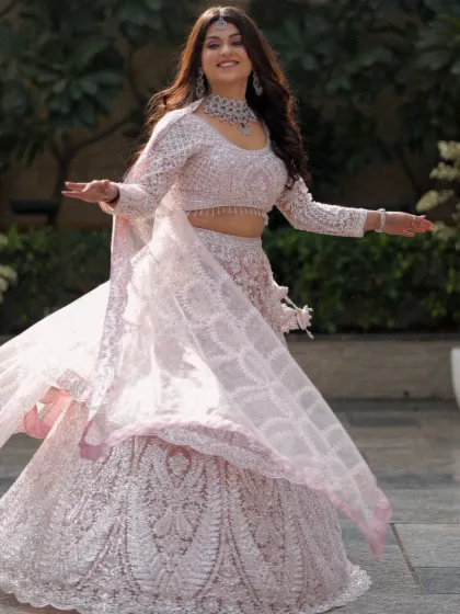 A joyful and candid bridal portrait. The bride's twirl shows off the beautiful movement of her lehenga and captures her infectious happiness and free spirit.