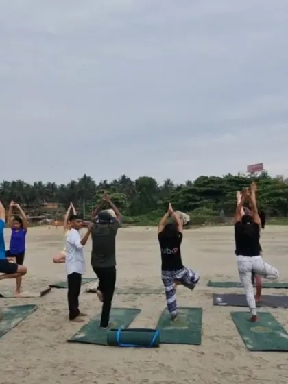 Finding our balance in Tree Pose (Vrikshasana) on the beach. The uneven surface of the sand adds a unique challenge, improving our focus and proprioception.