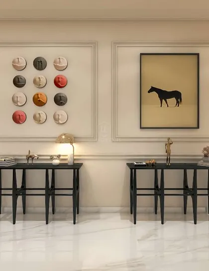 A minimalist console setup from the 'Nivasa' project. The symmetrical arrangement of two black tables against a paneled wall with modern art creates a clean, balanced, and artistic statement.