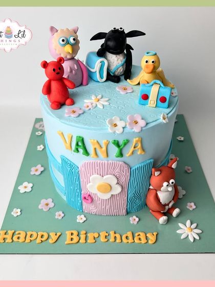 A charming storybook cake featuring beloved characters like an owl and a teddy bear, perfect for Vanya's birthday.
