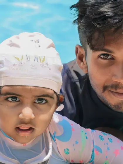 A close-up moment of trust between one of our certified coaches and a young swimmer. We believe early water exposure, guided with care, is the foundation for a lifetime of confidence in the pool.