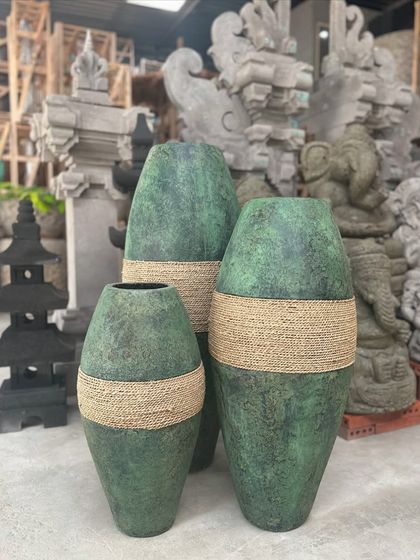 A beautiful set of three planters in a striking green finish with natural rope details. These pieces add a pop of color and texture, perfect for creating a coordinated display with varying heights.