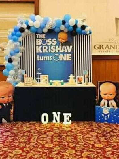A sophisticated Boss Baby themed first birthday with a navy blue and black color scheme and a custom milestone board.