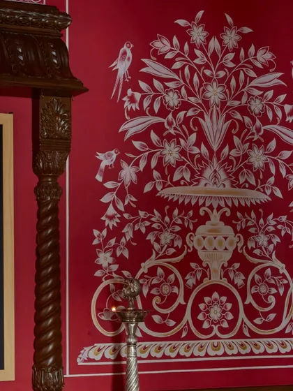 A close-up of the hand-painted motifs in the Hyderabad temple. The delicate birds and floral patterns, rendered with the subtle imperfections of the human hand, are what make the space feel so soulful. This is where bold design meets the quiet finesse of traditional craft.