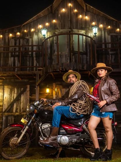A dramatic, night-time shot from the cowboy-themed set, with string lights adding a warm and magical atmosphere to the rustic scene.