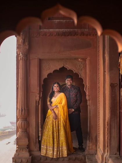 Framed by heritage, blessed by the Ganges. This couple's portrait uses the architectural beauty of the ghats to create a regal and timeless pre-wedding photograph.