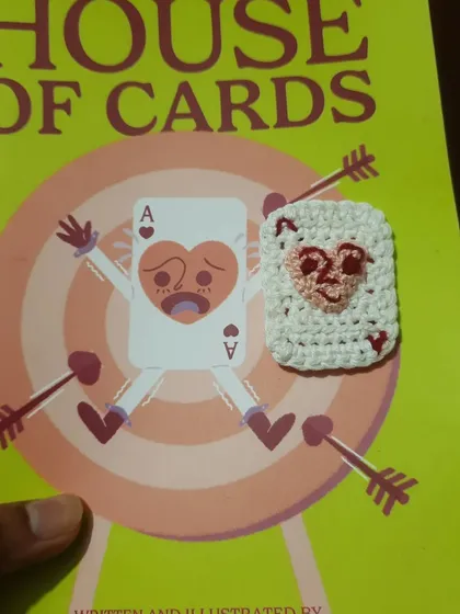 A project that was super close to my heart. This shows my "House of Cards" zine next to a tiny, handmade crochet version of the cover art. I love combining my illustration work with fiber art to create unique, matching sets like this.