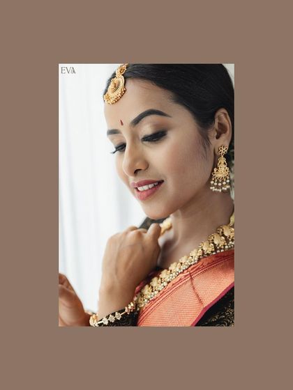 A close-up that captures the bride's serene expression and the fine details of her traditional gold jewelry.