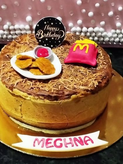 A fun and quirky cheesecake for a McDonald's lover. This baked cheesecake is topped with fondant McNuggets and fries.