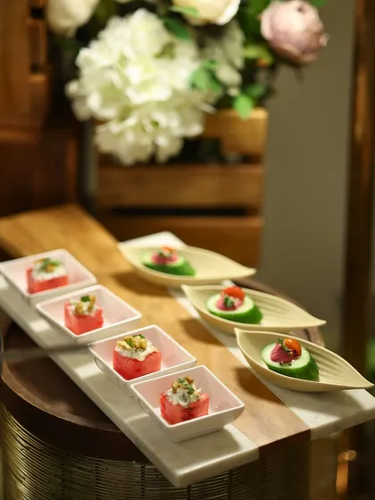 Another view of our artfully arranged canapés on a marble and wood board. We use premium serveware to enhance the visual appeal of our food.