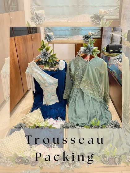 We believe a trousseau should be a work of art. Here, we've created an elegant display for the bride's outfits, using a beautiful wooden structure and delicate floral arrangements to turn her collection into a stunning showcase.