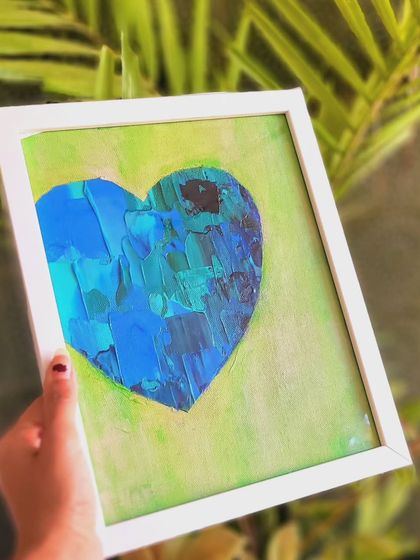 Holding this piece, you can see how the white frame makes the cool colors of the heart pop. The textured blues and greens against the soft lime background feel like a calm island in a gentle sea.