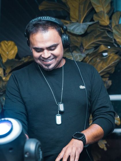 A smiling shot of me at the decks, enjoying the vibe of the night.