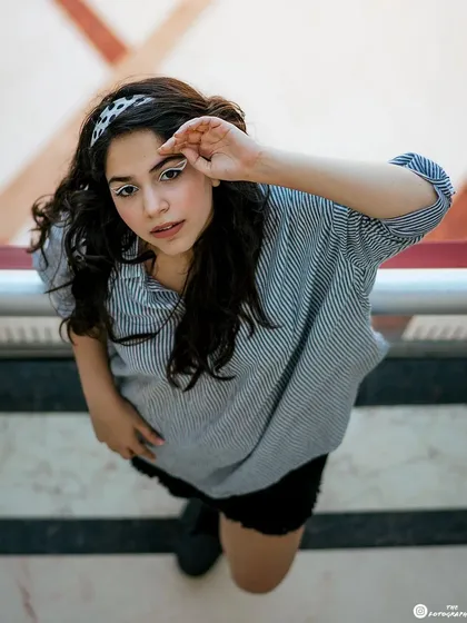 A creative high-angle shot taken outdoors. This perspective offers a unique and modern take on a casual portrait.