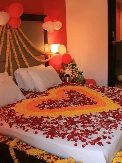 I also offer first night room decorations to continue the celebration. This room features a heart made of fresh flower petals on the bed, along with balloon and marigold string decorations.